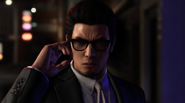 Kiryu listens to a message in his earpiece in Like a Dragon Gaiden: The Man Who Erased His Name.