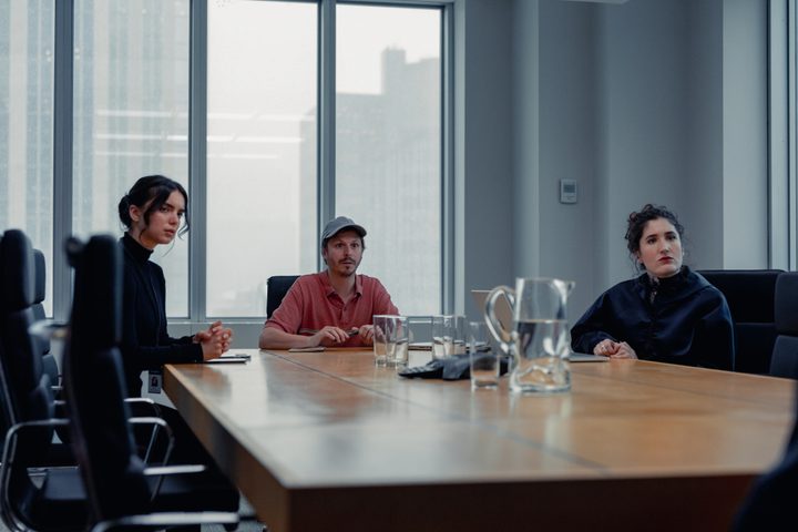 Michael Cera and Kate Berlant sit around a conference table in Dream Scenario.