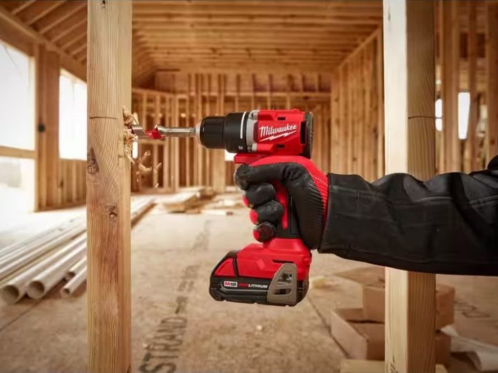 A man boring through a 2x4 with a Milwaukee M18 Drill/Driver.