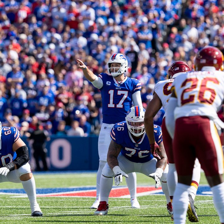 Josh Allen stands at the line of scrimmage and points.