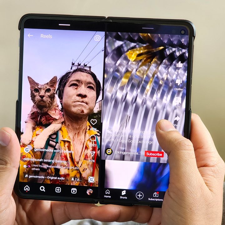 YouTube Shorts and Instagram running simultenously on OnePlus Open held in hands.