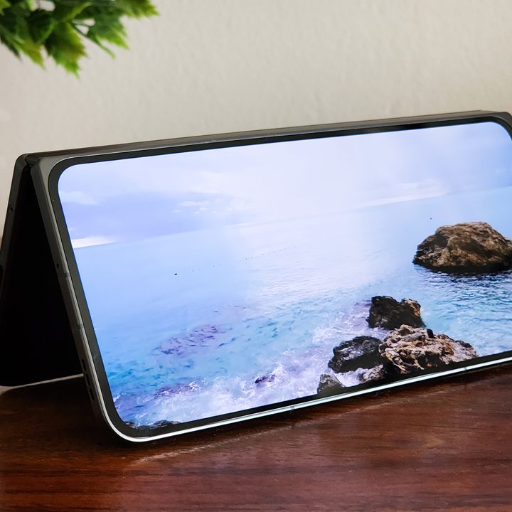 OnePlus Open playing a video while partially open and kept on a table top.
