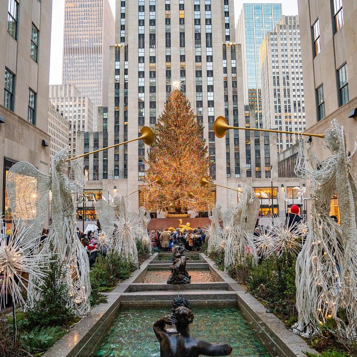 The Christmas tree at Rockefeller Center lights up.