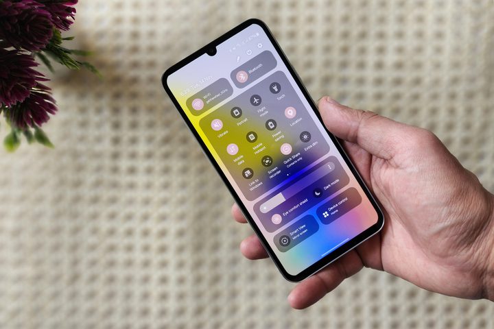 Samsung One UI 6 Quick Settings on Galaxy A34 held in hand.