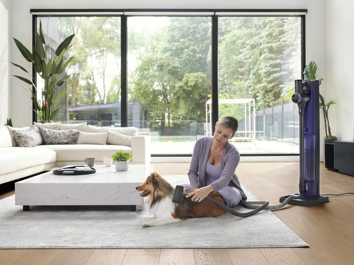 Tineco PURE ONE Station woman using to clean dog hair