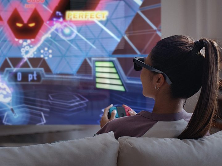 Woman using RayNeo VR glasses to play games.