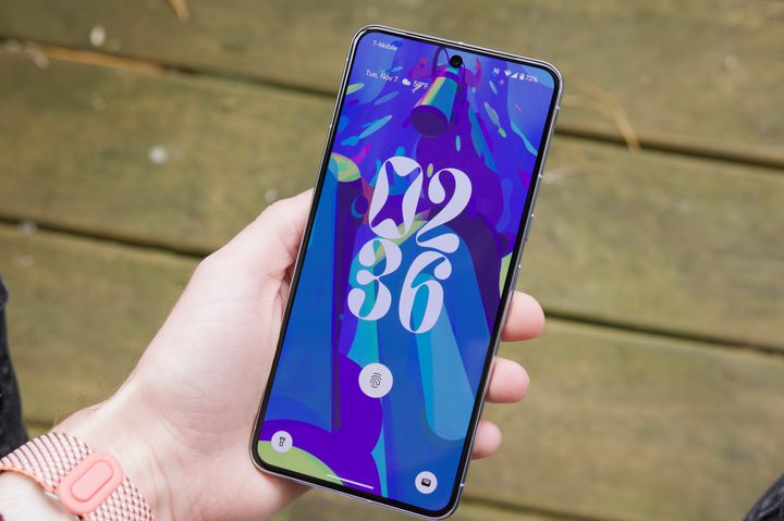 Someone holding the Google Pixel 8 Pro, showing its lock screen.