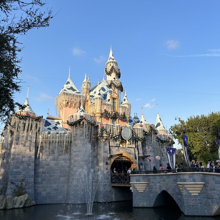 Sleeping Beauty Castle at Disneyland decorated for the holidays taken with iPhone 14.