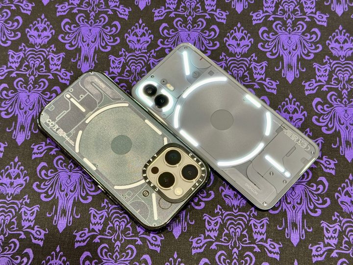 iPhone 15 Pro in Casetify Nothing Case along with a Nothing Phone 2.