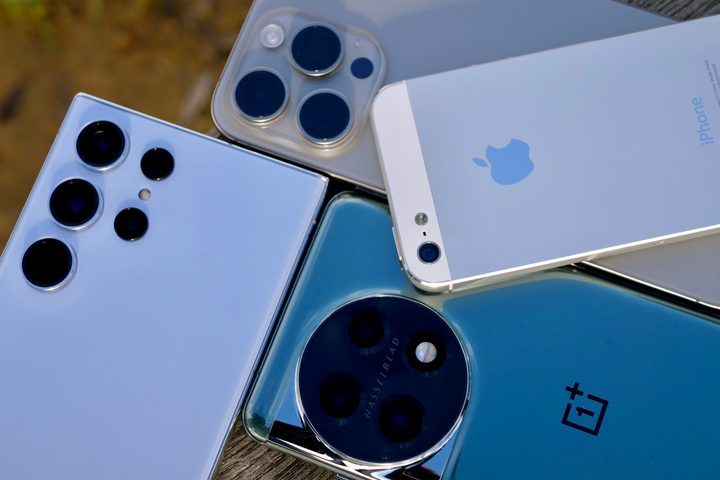 The iPhone 5, iPhone 15 Pro Max, Galaxy S23 Ultra, and OnePlus 11 cameras.