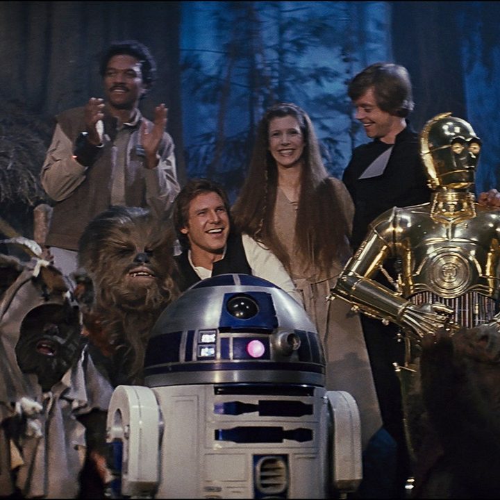 A screencap from the end of Return of the Jedi, showing the heroes on Endor.