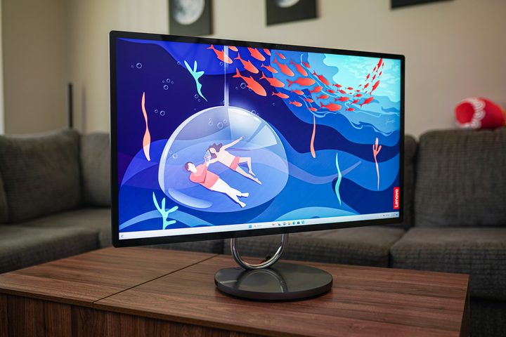 The Lenovo Yoga AIO 9i sitting on a coffee table.