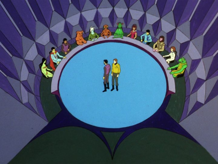 Kor and Kirk stand in the center of a council chamber in the Star Trek: The Animated Series episode "The Time Trap."