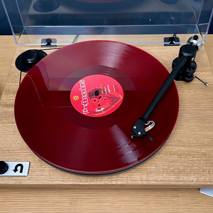 The U-Turn Orbit Special turntable with a red vinyl record on it.