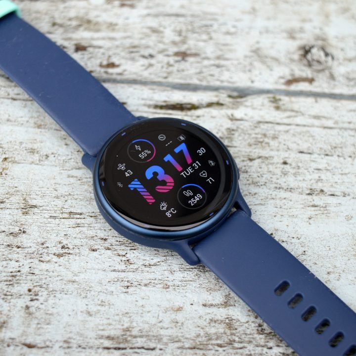 The Garmin Vivoactive 5 sits on painted wood, face up.