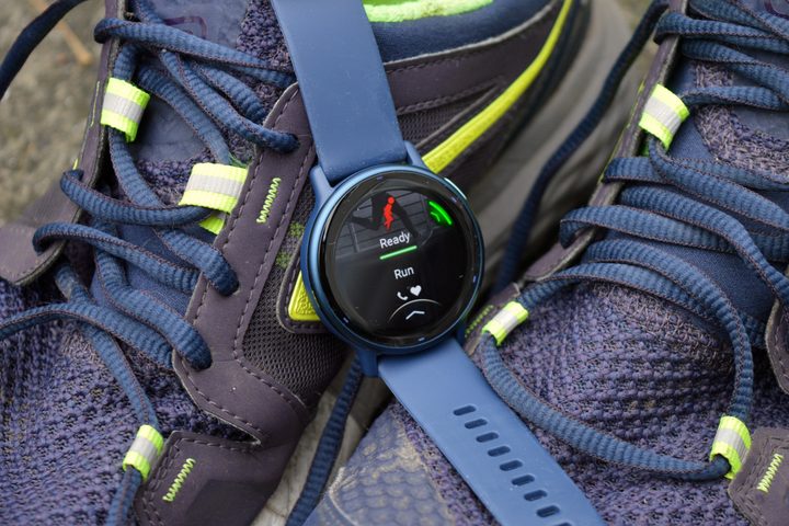 The Garmin Vivoactive 5 laid on some running shoes, close-up.