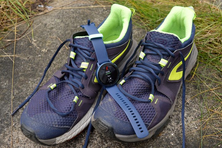 The Garmin Vivoactive 5 laid on running shoes.