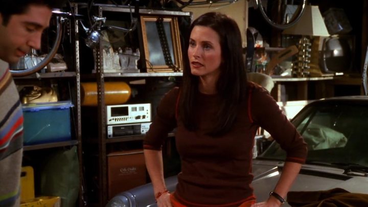 Monica looking upset in her parents' garage in Friends.