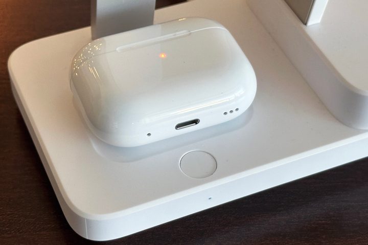 Closeup of AirPods Pro charging on ESR 6-in-1 charging stand and button to turn off CryoBoost.