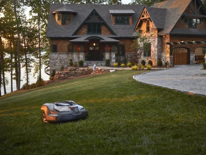 The Husqvarna Automower 450XH cutting grass on a nice, large lawn.