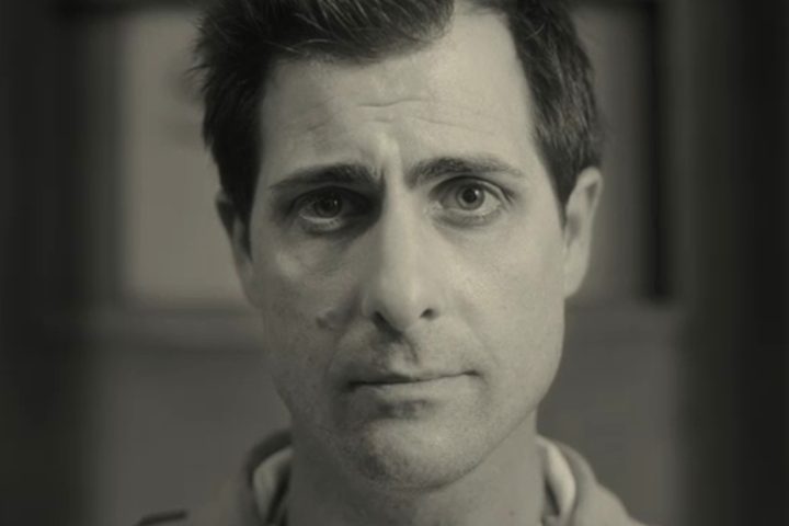 Jason Schwartzman smiles in Asteroid City.