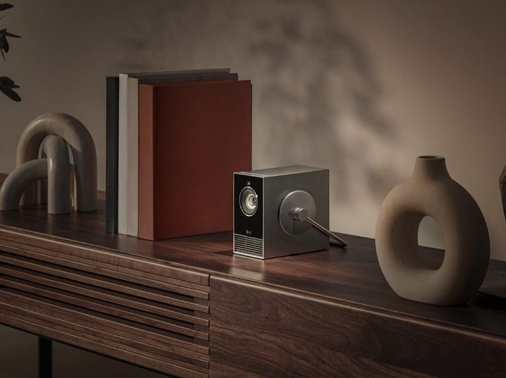 The LG CineBeam Qube (model HU710PB) seen on a bookshelf.