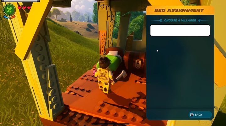 A lego person looking at a bed.