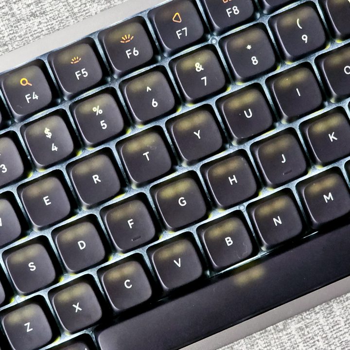 Backlight bleeding through black dye-sub PBT keycaps on Lofree Flow low-profile mechanical keyboard.