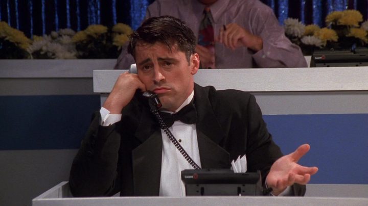 Joey wearing a tux and walking on the phone with an uncocerned expression in Friends.