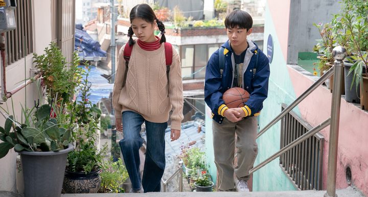 A boy and a girl walk together in Past Lives.