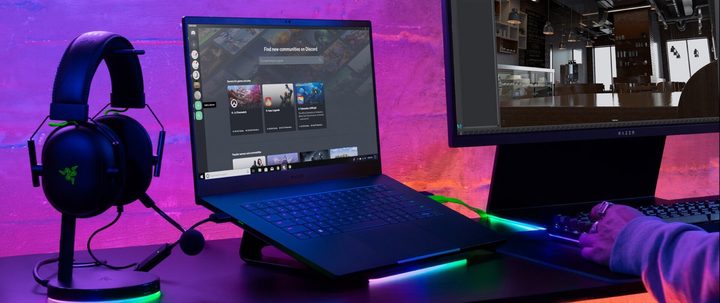 Press image of the Razer Blade 15 2023 laptop placed next to a headphone and display.