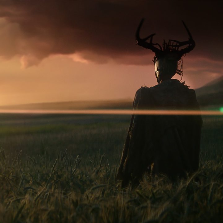 A melancholy droid watches the sunset in a still from Rebel Moon – Part One: A Child of Fire.
