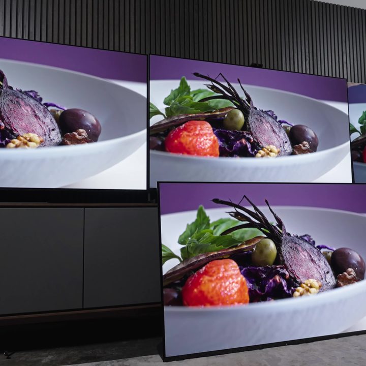 A white bowl of vegetables against a purple background compared on a Samsung S95C, Sony A95L, LG G3, and Sonly A95K TV.