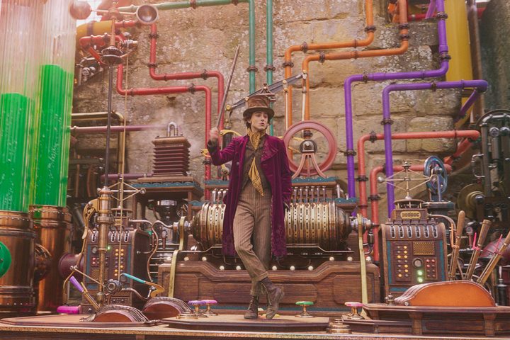 Timothée Chalamet dances in a multicolored factory in Wonka.