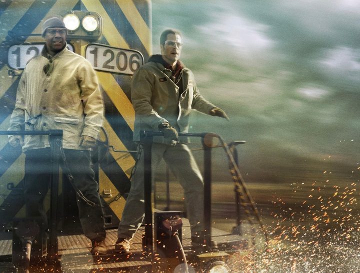 Two men stand on the back of a train in Unstoppable.