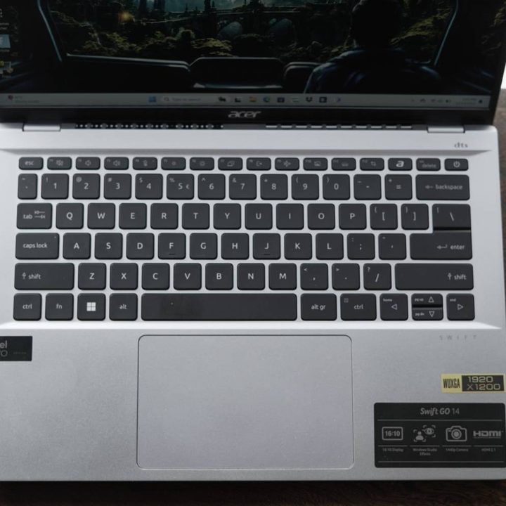 The keyboard of the Acer Swift Go 14 on a wooden table.