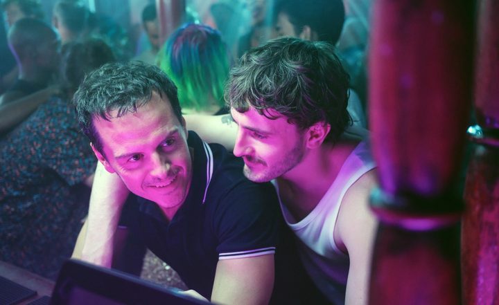 Two men hang out in a bar in All of Us Strangers.