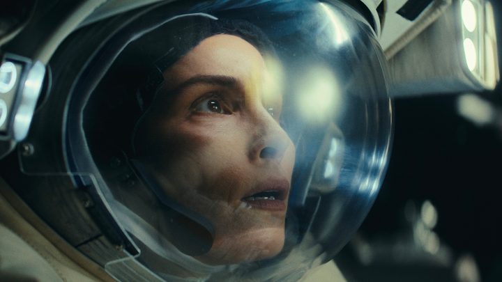 A female astronaut looks up in horror in a scene from Constellation.