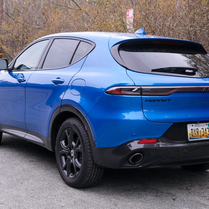 A rear three-quarter view of a blue Dodge Hornet R/T.
