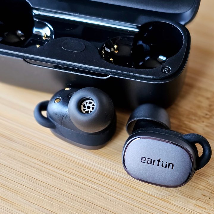 EarFun Free Pro 3 beside charging case.