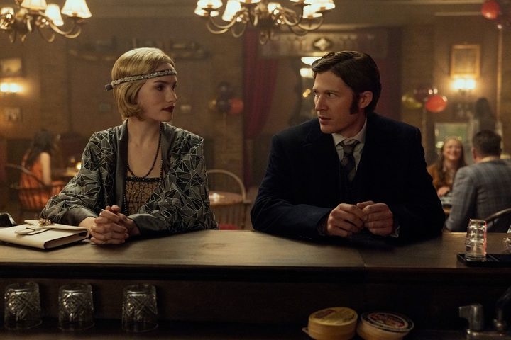 Two people sit at a bar in The Fall of the House of Usher.