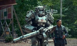 Aaron Moten stands next to someone wearing power armor in Fallout.