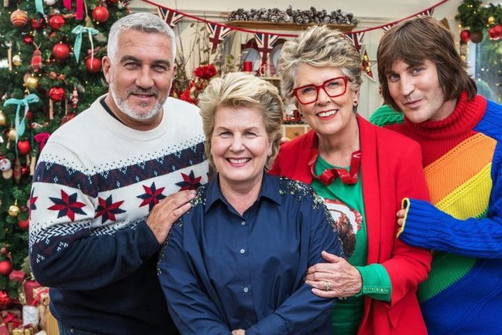 Four people pose in The Great British Baking Show: Holidays.