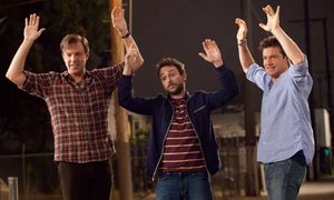Three men with their hands up in the air in a scene from Horrible Bosses.