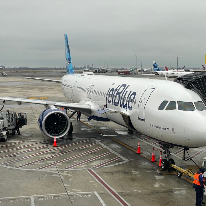 A JetBlue airplane at the airport gate.