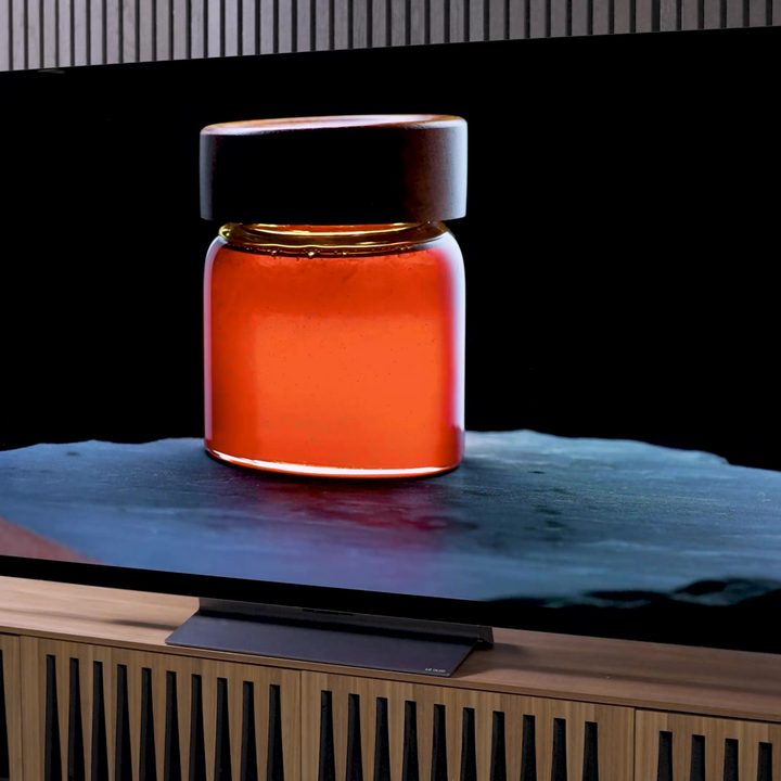 A backlit jar of amber liquid displayed on an LG C3 OLED.
