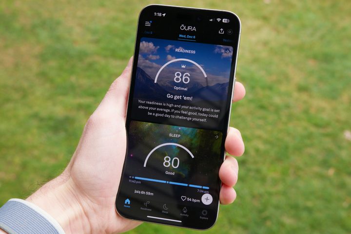 Someone holding an iPhone with the Oura app running on it.
