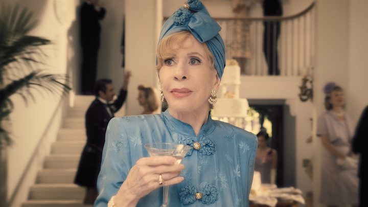 Carol Burnett holding a drink and dressed up in a scene from Palm Royale on Apple TV+.