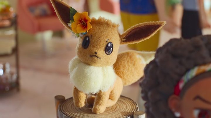Eevee sits on a tree stump in Pokemon Concierge.
