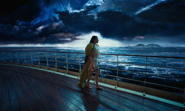 A woman walks on a boat in Poor Things.